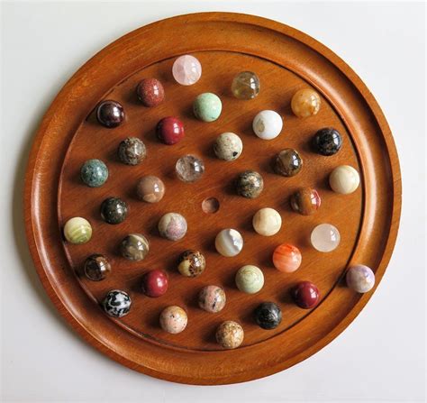 32 and 36 marble versions. Large Marble Solitaire Board Game with 37 Agate Marbles, Late 19th Century at 1stdibs