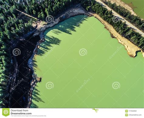 Green Lake With Emerald Water In The Middle Of The Forest Stock Photo