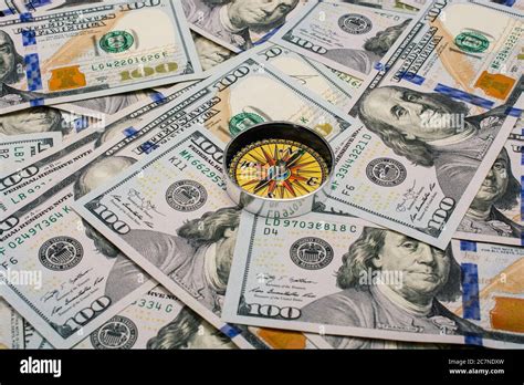 economic direction concept with compass on US dollar banknotes Stock