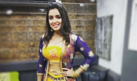 bhojpuri hottie amrapali dubey looks sexy as she flaunts her washboard abs in yellow lehenga