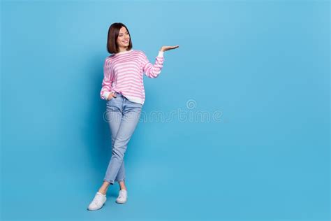 Photo Of Charming Pretty Woman Wear Striped Sweater Holding Arm Empty