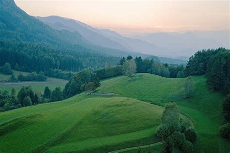 Rolling Landscape With Mountain Range In Background At Dusk Photograph