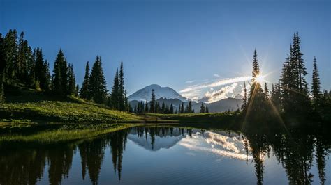 Download 1366x768 Lake Sunshine Forest Grass Mountain Wallpapers