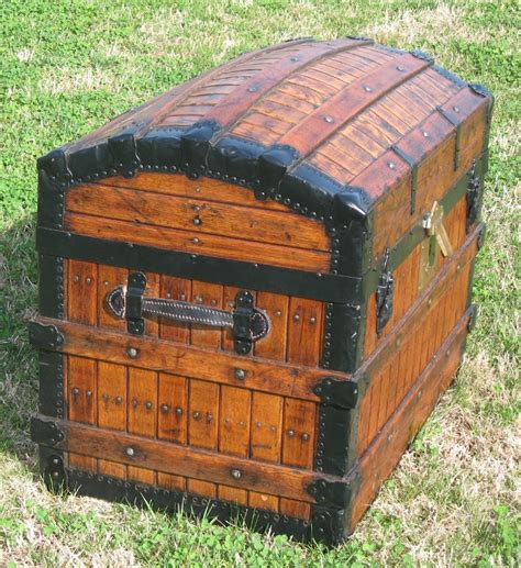 An Old Wooden Chest Sitting In The Grass