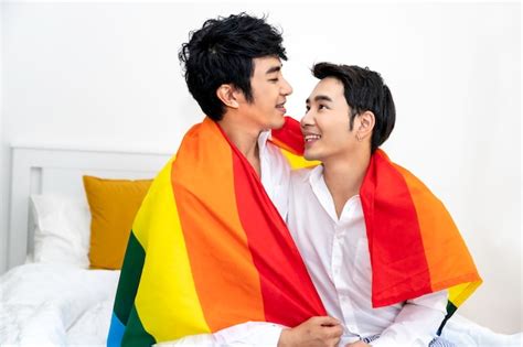 Premium Photo Portrait Of Asian Homosexual Couple Hug And Holding Hand With Pride Flag In