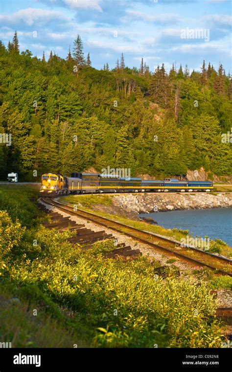 An Alaska Railroad Passenger Train Rounds A Corner Along Turnagain Arm