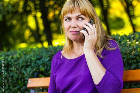 defocus caucasian blond woman talking on the phone outside outdoor 40s years old woman in