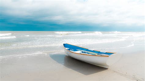 Boat On Sea Shore Under Blue And Cloudy Sky 4k Hd Nature Wallpapers