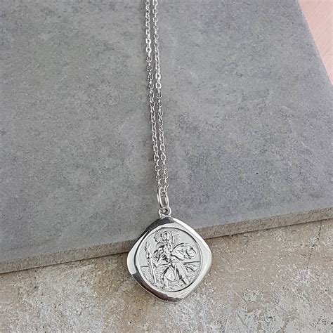 Religious medals like a saint christopher medal are often worn as a necklace by placing a wearing a necklace like this has the devotional effect of helping you keep company with st. Personalised Saint St Christopher Necklace Pendant By ...