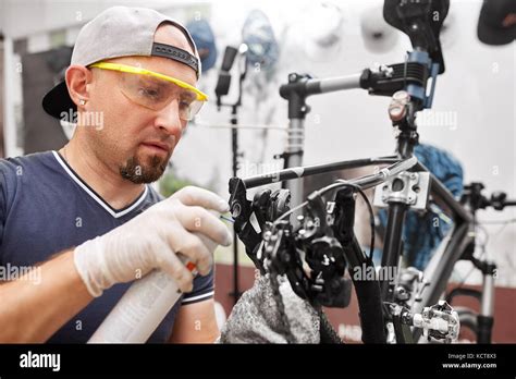 Mechanic Repairing Bicycle In His Workshop Bicycle Service Stock Photo