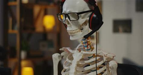 How many sitting skeleton stock photos are there? Medium shot of a skeleton wearing headphone dancing while ...