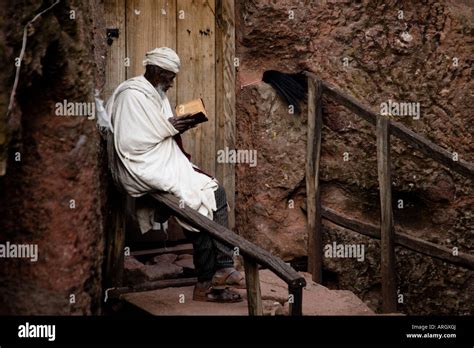 Monk Reading The Bible In Front Of A Church Golgotha Church Lalibela