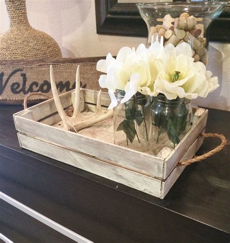A coffee table is a low table designed to be placed in a sitting area for convenient support of beverages, remote controls, magazines, books (especially large, illustrated coffee table books), decorative objects, and other small items. White distressed tray/Stain distressed tray w/brackets