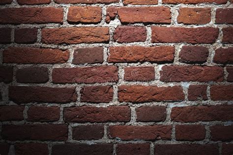 Grungy Dark Red Brick Wall With Spotlight Background Texture Stock