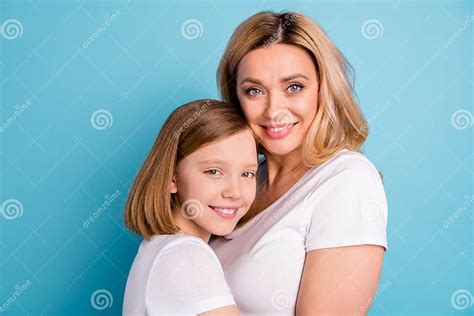 cloeup profile photo of two people beautiful mommy lady small little daughter blonds hugging