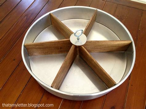 You can build a turntable like this by mounting lazy susan hardware to a scrap of particleboard or plywood, and then mounting a plywood or particleboard disc to the hardware. That's My Letter: DIY Tabletop Lazy Susan