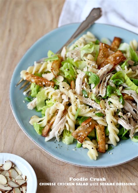 Lightly dressed chinese chicken salad with grilled chicken, crunchy wontons, toasted almonds, and sprinkled with sesame seeds over a crunchy napa cabbage and carrot salad. Chinese Chicken Salad with Sesame Dressing | Foodiecrush.com