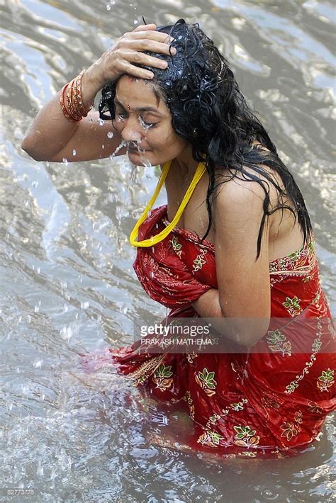 A Nepalese Hindu Woman Takes A Ritual Bath In The Bagmati River During The Rishi Panchami