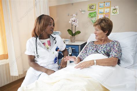 nurse preparing a patient for an iv line stock image f006 8874 science photo library