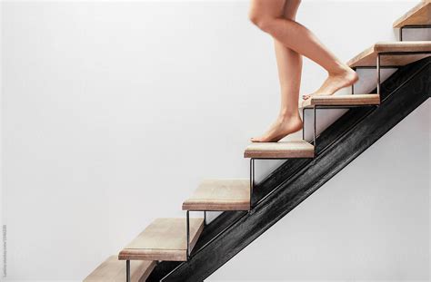feet of a woman going down the stairs by stocksy contributor lumina stocksy
