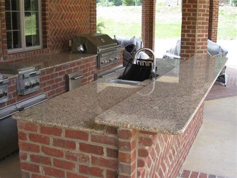 The construction process of an outdoor kitchen can be complicated. Outdoor Brick Kitchen | Artisan Interiors And Builders
