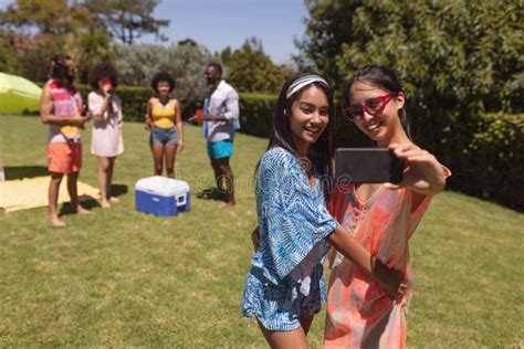 Two Mixed Race Female Friends Taking Selfie At A Pool Party Stock Image Image Of Race Green