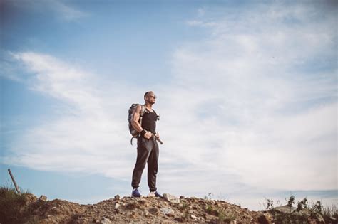 Man Standing On The Top Of A Mountain Stock Photo Download Image Now