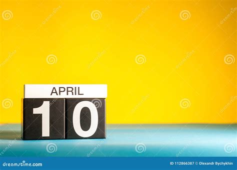 April 10th Day 10 Of April Month Calendar On Table With Yellow
