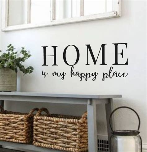 A Wall Decal That Says Home Is My Happy Place With Baskets On The Shelf
