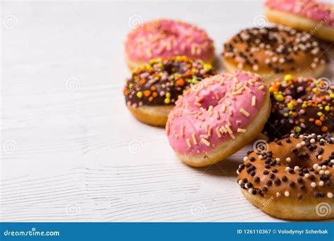 Assorted Donuts With Chocolate Frosted Pink Glazed And Sprinkles