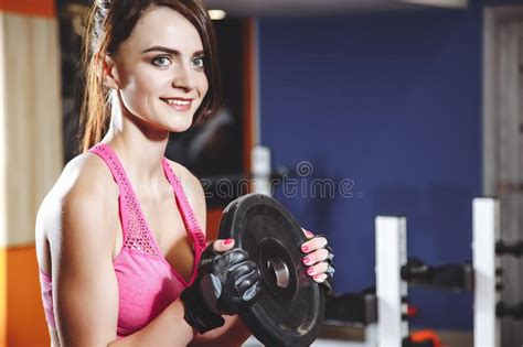Woman Doing Fitness Training On A Butterfly Machine With Weights In Gym
