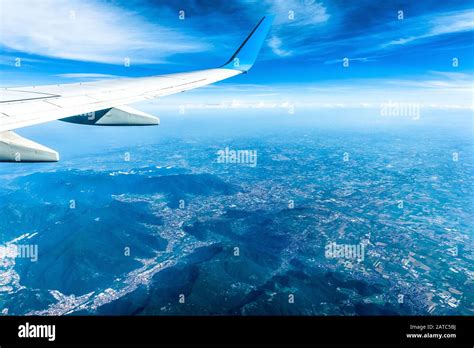 Wing Of Airplane Flying Above European Mountains Flight Over Alps The