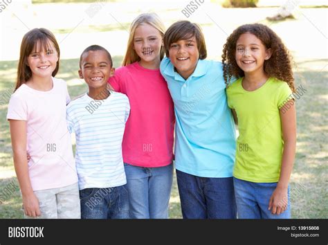 Portrait Of Group Of Children Playing In Park Stock Photo And Stock