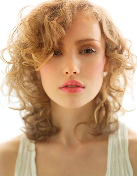 The hair's natural texture is left to shine on its own, with little other than a center part providing the sex. Wash and Wear Hairstyles Ideas|