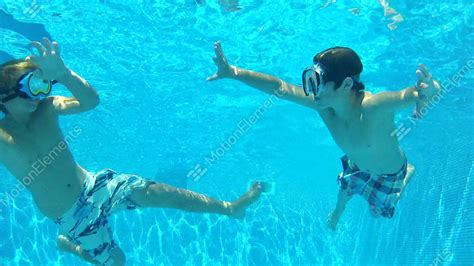 Two Boys Swimming Underwater Together Stock Video Footage 3280495