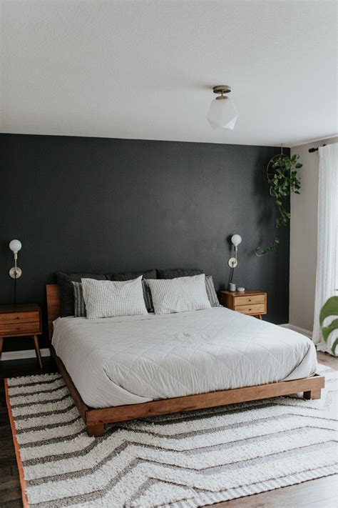Wooden bed with thick gadi work and wooden back rest side unit. Black accent wall, wood mid century modern nightstands ...