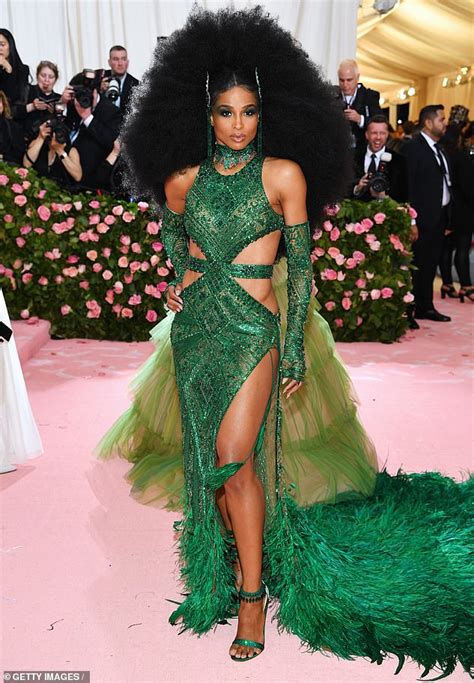 ciara makes her met gala grand entrance in emerald green cut out gown complete with a large afro