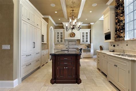 Kitchen With Tall Ceilings Cabinetry Spans Both Sides With Dark Island