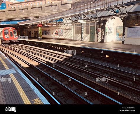 District Line Train Pulling Into Bow Road Tube Station Stock Photo Alamy