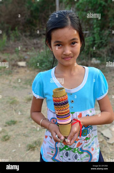 Young Cambodian Girl Offers Her Woven Bracelets And Ringsjewelry For Sale To Passengers From