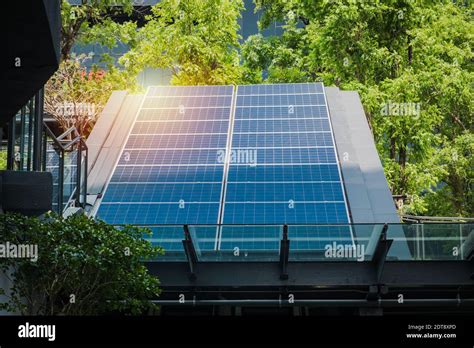 Photovoltaic Solar Power Panels Installed On Modern Building Rooftop In