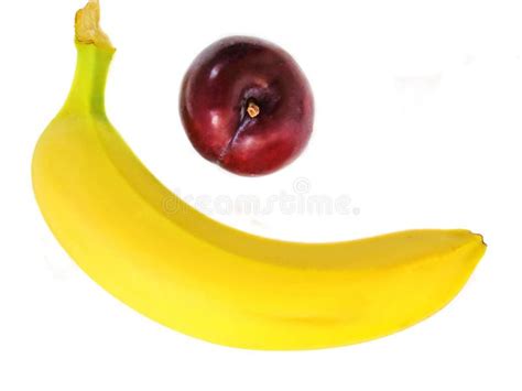 Banana And Plum In The Form Of A Smiling Emoticon On A White Plate
