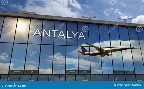 Airplane Landing At Antalya Turkey Airport Mirrored In Terminal Stock