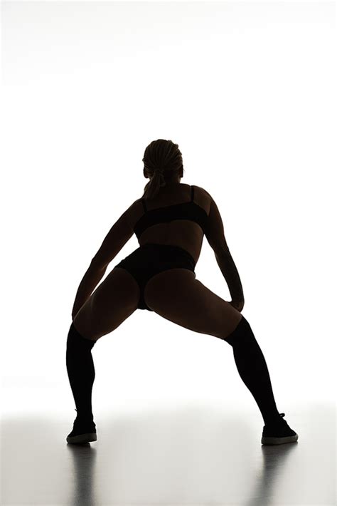 Back View Of Silhouette Of Sexy Girl Twerking On Floor Isolated On White