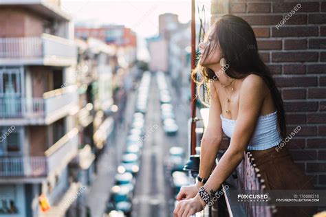 Side View Of Brunette Girl Posing Romantically On Balcony — Focus On Foreground Alone Stock