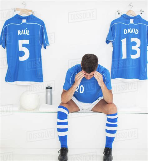 Soccer Player With Head In Hands In Locker Room Stock Photo Dissolve