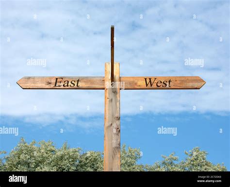Signpost To The East And West Stock Photo Alamy
