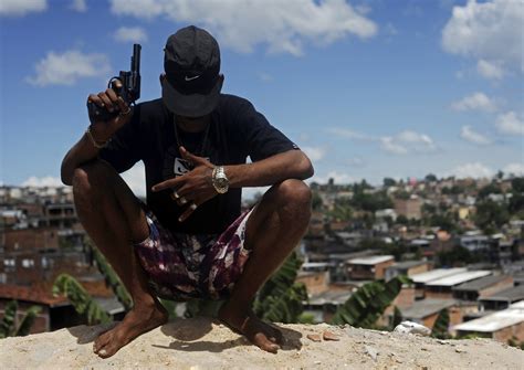 A Brazilian Drug Gang Member Nicknamed Firecracker Poses With A Gun