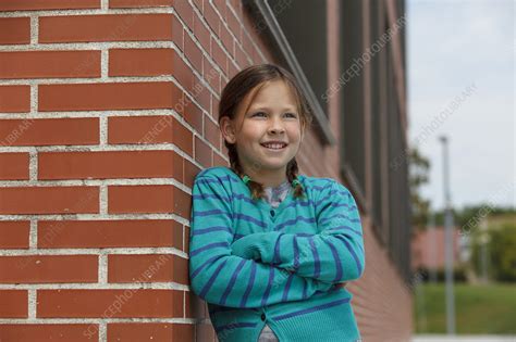 Smiling Girl Leaning Against Brick Wall Stock Image F0064535