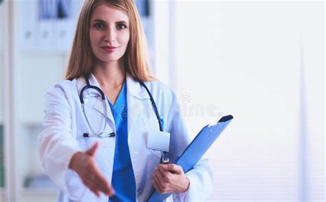 Portrait Of Woman Doctor With Folder At Hospital Corridor Stock Image